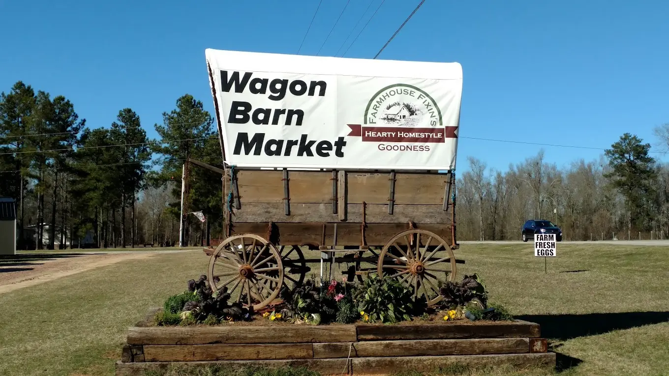 Mennonite Wagon Barn Market entrance sign. Buy ready-to-serve dinners, pastries, and other grocery items.
